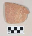 Red bodied earthenware base sherd, with red slip exterior and buff slip interior