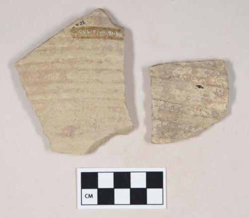 Molded coarse buff bodied earthenware body sherds, with green slip