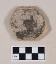 Coarse buff bodied earthenware base sherd, unslipped, blackened interior