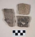 Coarse gray bodied earthenware body sherds, with red slip; two sherds crossmend