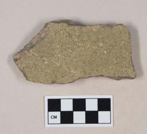 Coarse green bodied earthenware body sherd, with green slip, reduced core