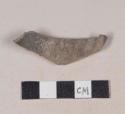 Buff bodied earthenware body sherd, with gray slip, wheel thrown