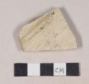 Coarse buff bodied earthenware body sherd, with buff slip and incised lines