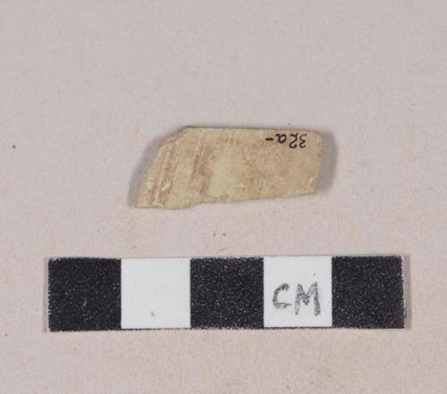 Buff bodied earthenware rim sherd, with buff slip and brown slipped stripes, wheel thrown