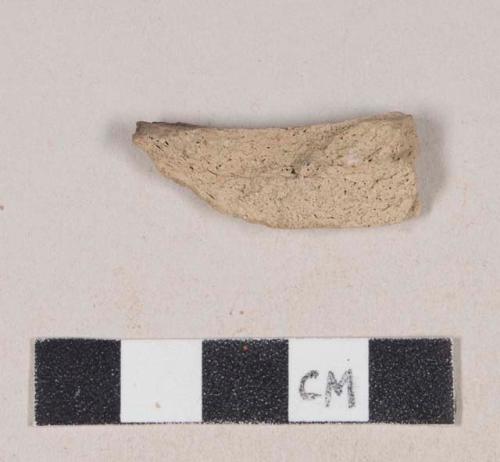 Coarse buff bodied earthenware body sherd, unslipped, partially blackened interior