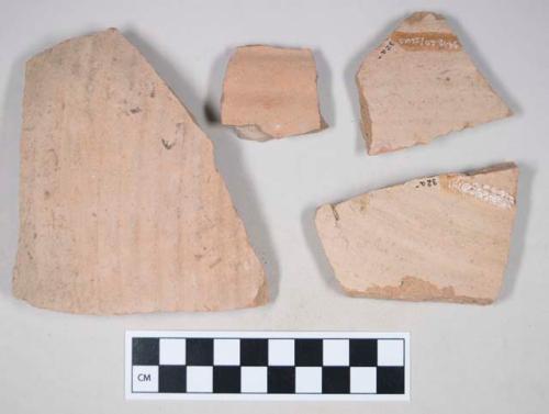 Molded coarse red bodied earthenware body sherd, with red slip; three sherds crossmend