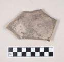 Coarse gray bodied earthenware body sherd, with brown slip