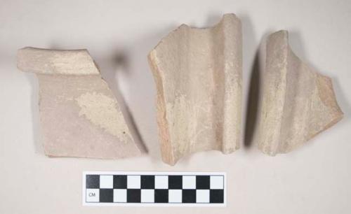 Coarse red bodied earthenware rim sherds, with buff slip; two sherds crossmend