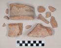 Coarse red bodied earthenware body sherd, with buff slip; two sherds crossmend