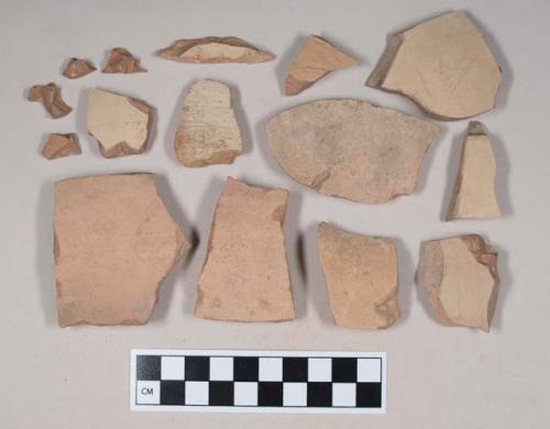 Red bodied earthenware body sherds, with buff slip; two sherds crossmend; six sherds crossmend