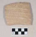 Molded coarse buff bodied earthenware body sherd, with buff slip