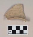 Coarse red bodied earthenware rim sherd, with buff slip and incised lines