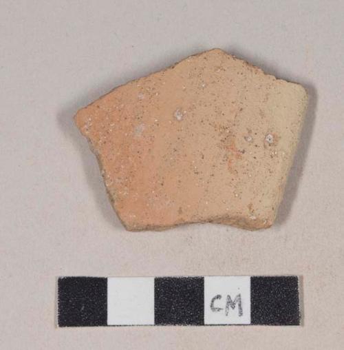 Coarse red bodied earthenware rim sherd, with buff slip