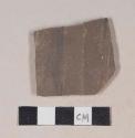 Gray bodied earthenware body sherd, with brown slip, wheel thrown