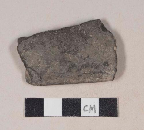 Coarse gray bodied earthenware rim sherd, with gray slip