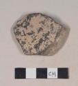 Coarse gray bodied earthenware rim sherd, with brown and gray slip