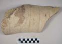 Coarse red bodied earthenware body sherd, with buff slip and incised decorations