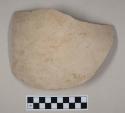 Red bodied earthenware body sherd, with buff slip, blackened interior, reduced core