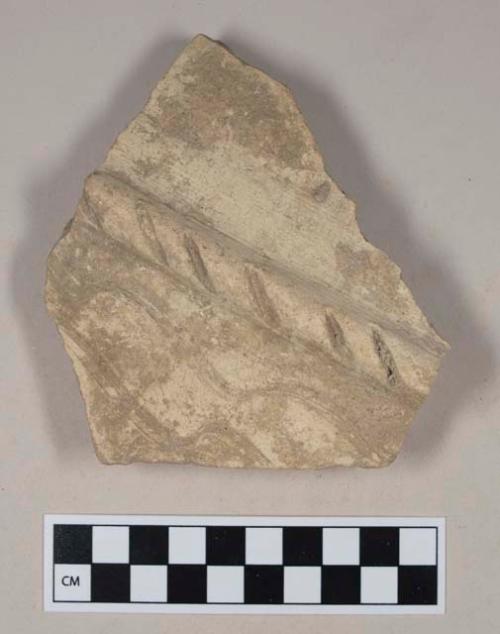 Coarse red bodied earthenware body sherd, with buff slip and molded and incised decoration