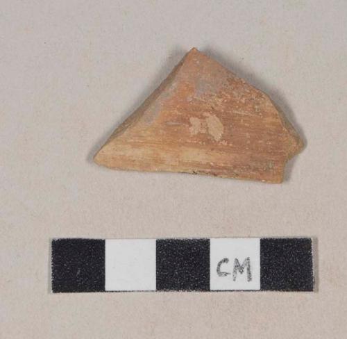 Buff bodied earthenware rim sherd, with red slip and black slipped stripe, wheel thrown