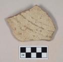 Molded, coarse red bodied earthenware body sherd, with green slip