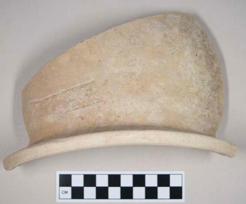 Coarse red bodied earthenware rim sherd, with buff slip, seal impression