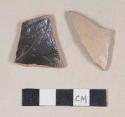Buff/pink-bodied, gray salt glazed stoneware body sherds with albany slipped interior; two sherds crossmend