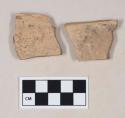 Red bodied earthenware rim sherds, with red slip, reduced core; two sherds crossmend