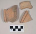 Red bodied earthenware rim sherds, with red slip, wheel thrown; two sherds crossmend
