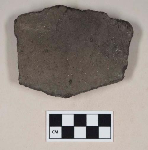 Coarse black bodied earthenware body sherd, with gray slip