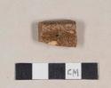 Slip decorated, lead glazed redware rim sherd