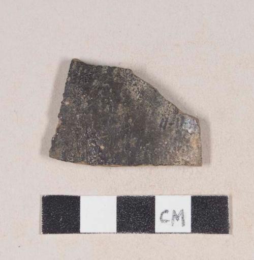 Burned, undecorated, lead glazed redware body sherd