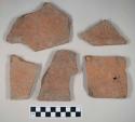 Redware roof tile fragments, one with nail hole