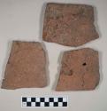 Redware roof tile fragments, some with nail holes