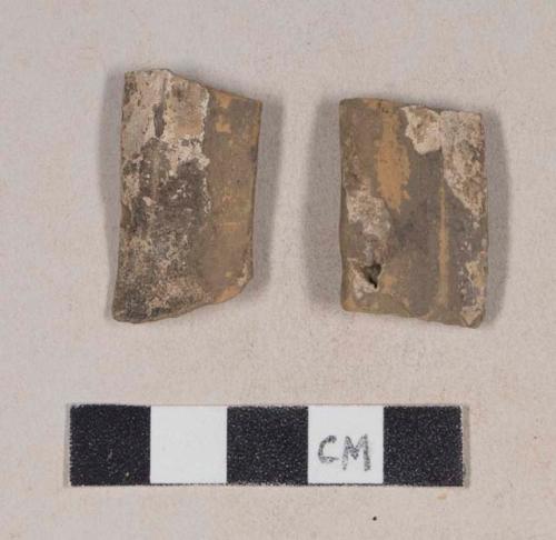 Burned, lead glazed redware handle sherds; two sherds crossmend