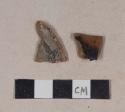 Undecorated, lead glazed redware base sherds; one possibly burned