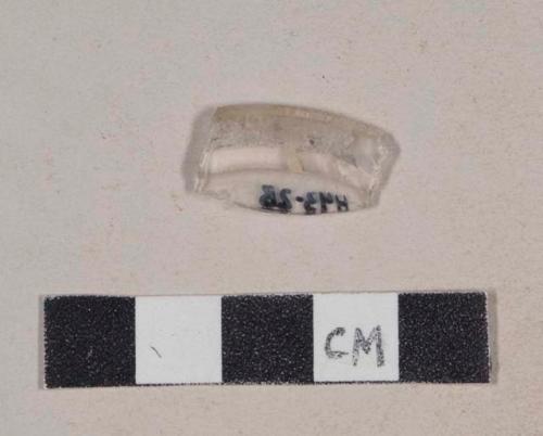 Folded colorless glass rim fragment, possibly stemware base fragment