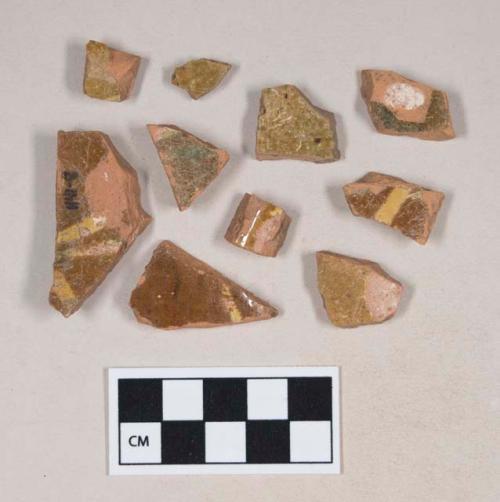 Slip decorated, lead glazed redware body sherds; two sherds crossmend