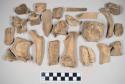 Animal bone fragments, some with butchery marks; one with possible copper staining. Includes long bones, ribs, vertebrae; mostly mammal