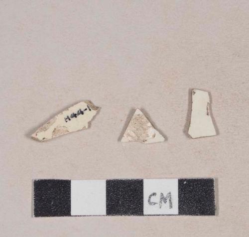 Undecorated creamware body sherds; two sherds crossmend