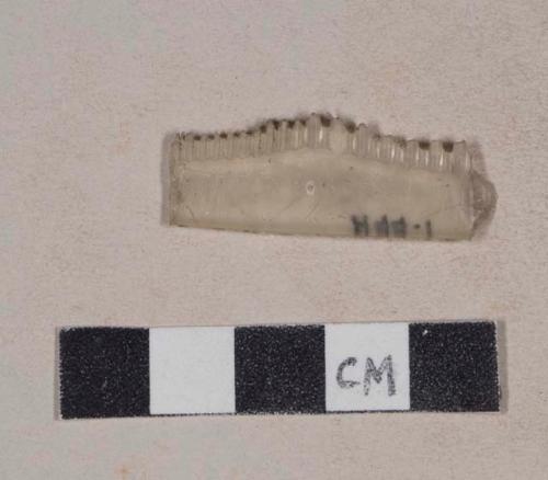 Colorless plastic comb fragment