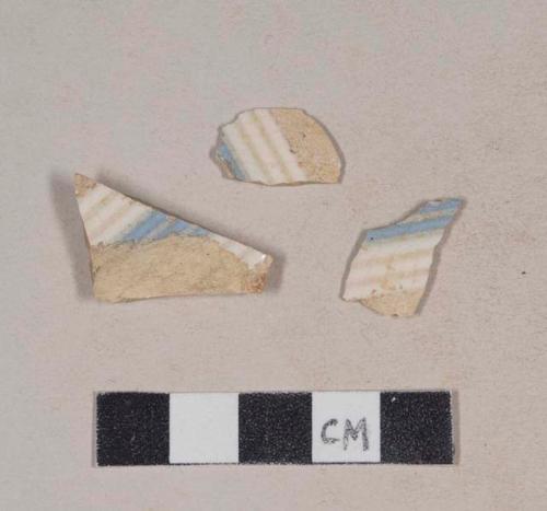 Refined earthenware body sherds, with white and blue glazed stripes and molded ridges; two sherds crossmend