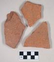 Redware roof tile fragments, one with nail hole