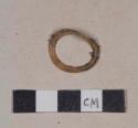 Synthetic ring with iron fragments adhered, likely part of an iron crown bottle cap