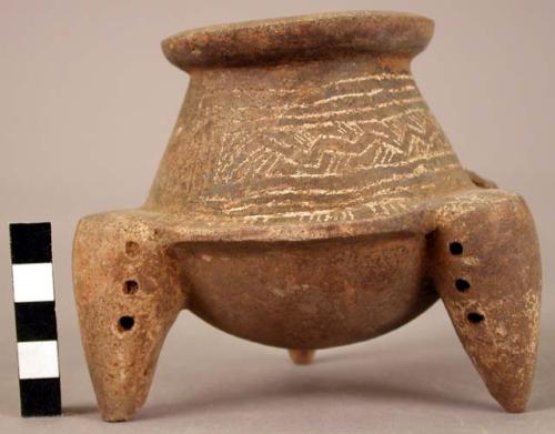 Small Guinea pottery tripod vessel with incised and painted designs