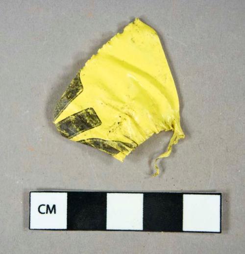 Synthetic, plastic, clear wrappers and yellow construction tag