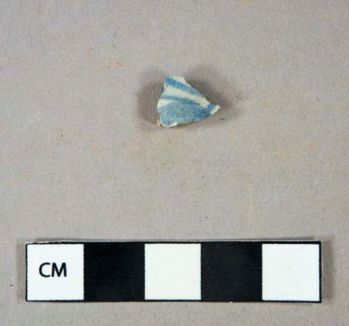 Ceramic, earthenware, tin glazed body sherd with hand painted blue exterior decoration