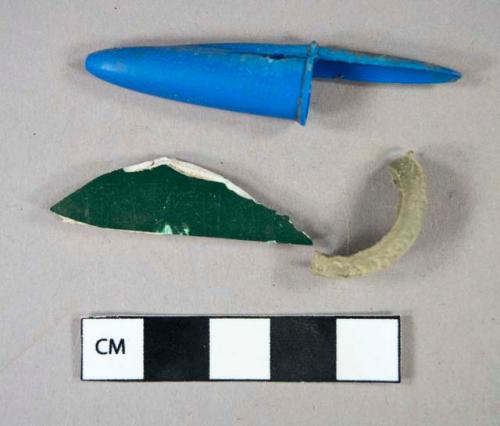 Plastic fragments including utensil handle and blue pen cap