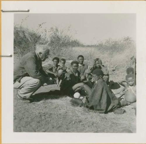 Gau, "Old ≠Toma," /Gam and //Khuga (wife of !Naishi) sitting with Laurence Marshall