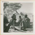 Group of people sitting and talking with Laurence Marshall and Lorna Marshall